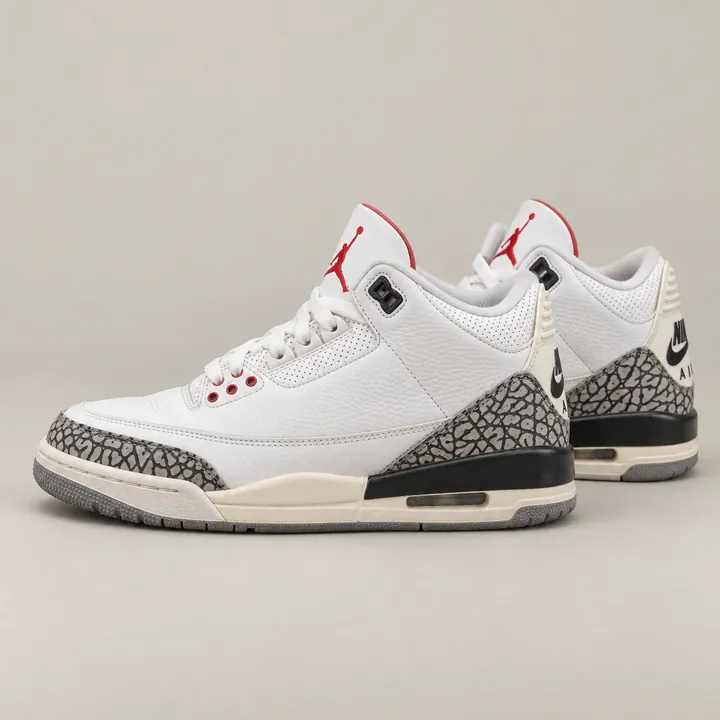 Nike Air Jordan 3 White Cement Reimagined sneakers on a grey studio backdrop