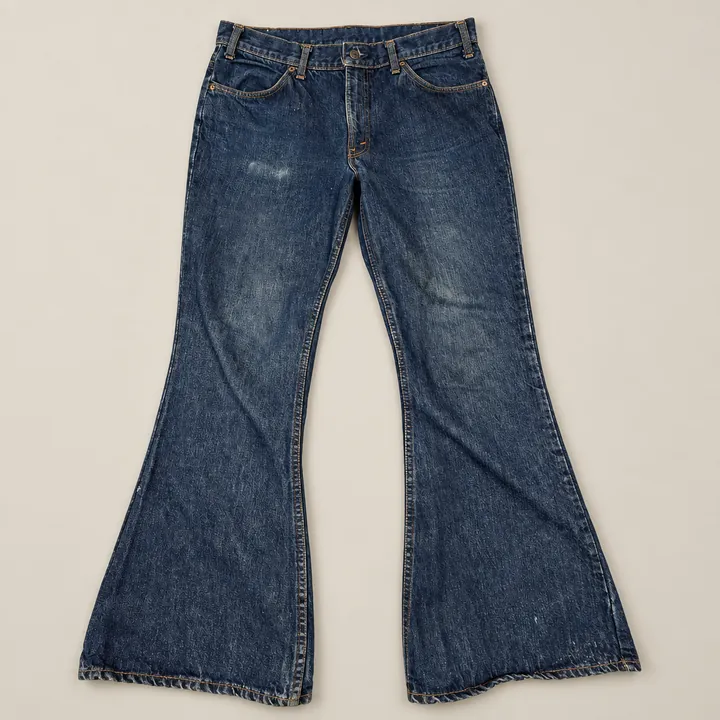 Vintage Levi's 646 dark indigo bell bottom jeans laid flat