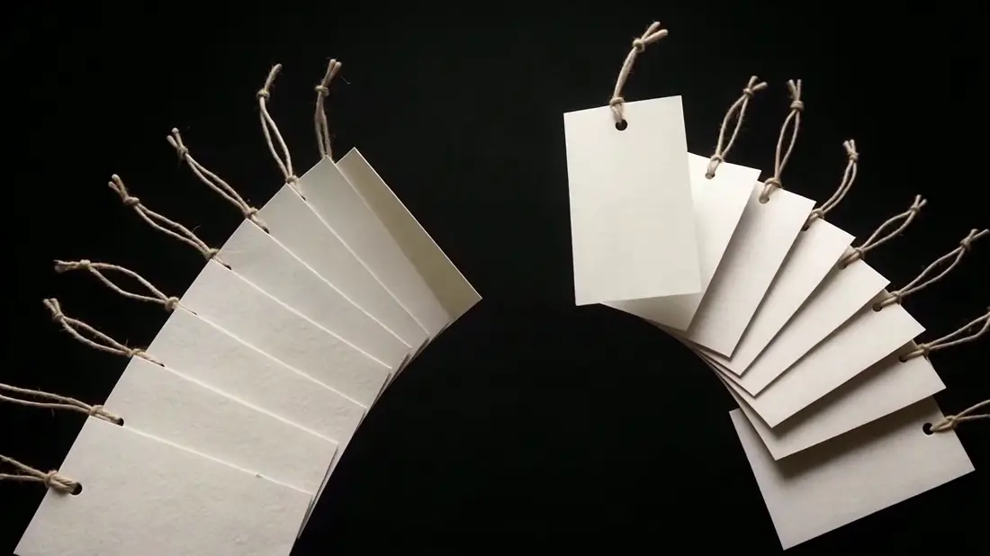A fanned stack of blank paper price tags spreading open